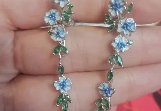 Glossy Blue Floral Dangling Earrings worn by a customer