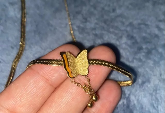 Dainty Herringbone Butterfly Dangle Necklace worn by a customer