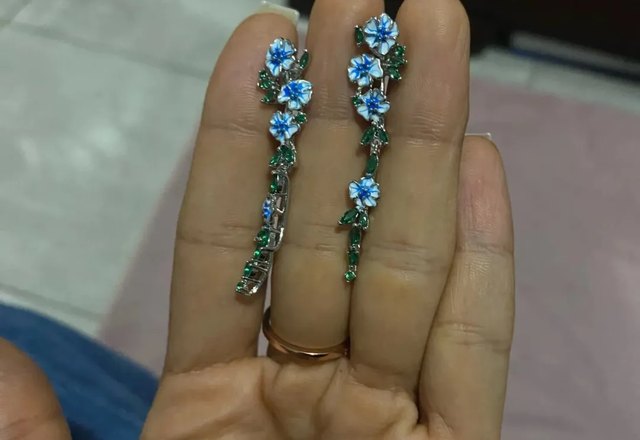 Glossy Blue Floral Dangling Earrings worn by a customer