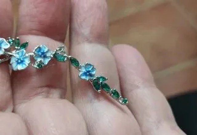 Glossy Blue Floral Dangling Earrings worn by a customer