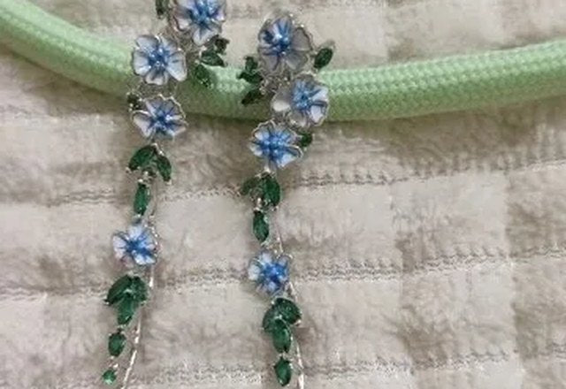Glossy Blue Floral Dangling Earrings worn by a customer