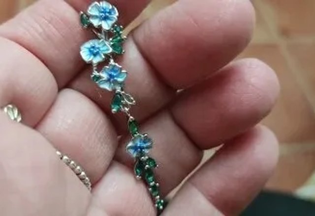 Glossy Blue Floral Dangling Earrings worn by a customer