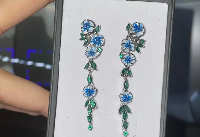 Glossy Blue Floral Dangling Earrings worn by a customer