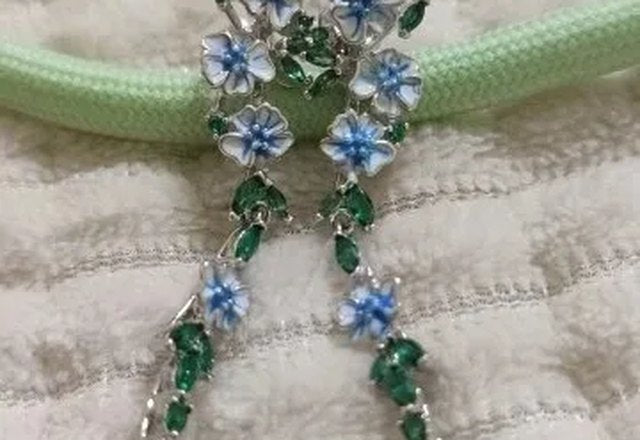 Glossy Blue Floral Dangling Earrings worn by a customer