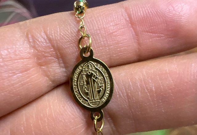 14k Virgin Mary & Jesus Christ Heart Cross Hand Chain worn by a customer
