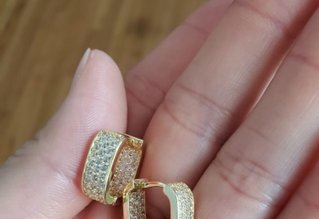 Chunky Glittering Hoop Earrings worn by a customer