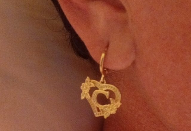 Initial Letter Heart Hoops worn by a customer